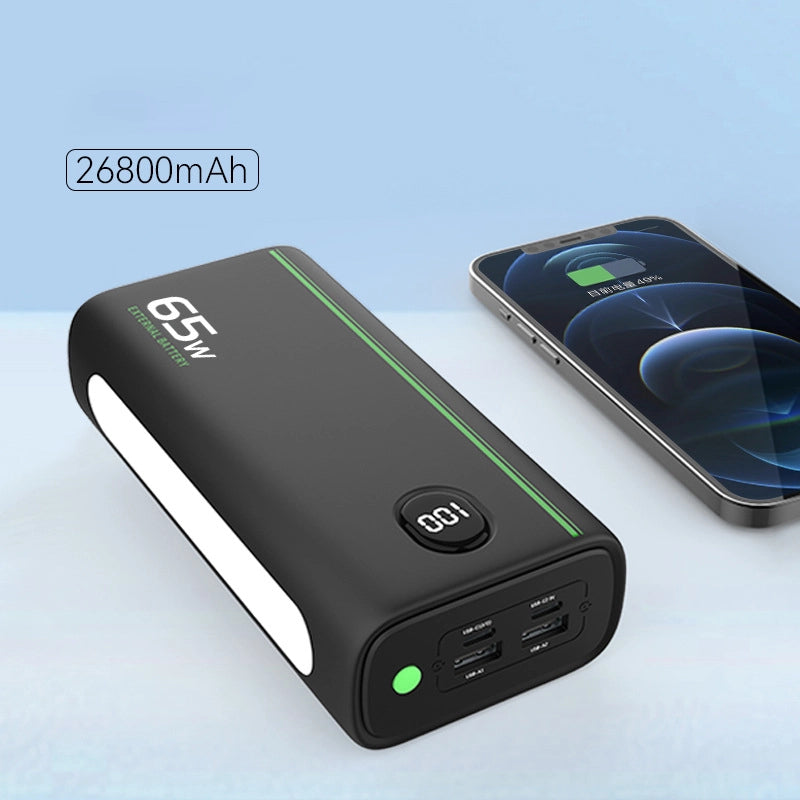 65W Two-Way Fast Charging 26800mAh Power Bank, lying down next to an iPhone, highlighting size comparison and compatibility