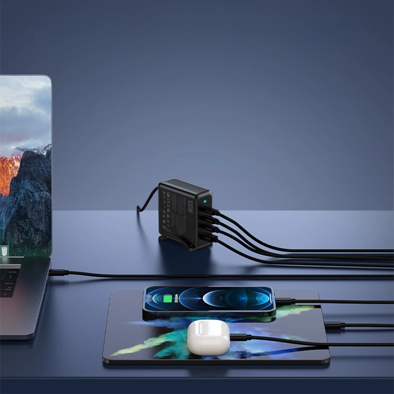 PD100W GaN Multi-Port Charger for Laptops & Phones, black variant in an angled view on a table, with an iPhone, iPad, AirPods, and laptop charging